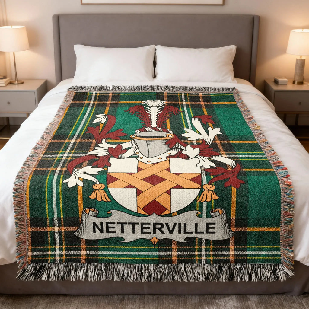 Green plaid blanket with Netterville family crest displayed centrally on a bed.