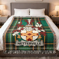 Green plaid blanket with Netterville family crest displayed centrally on a bed.