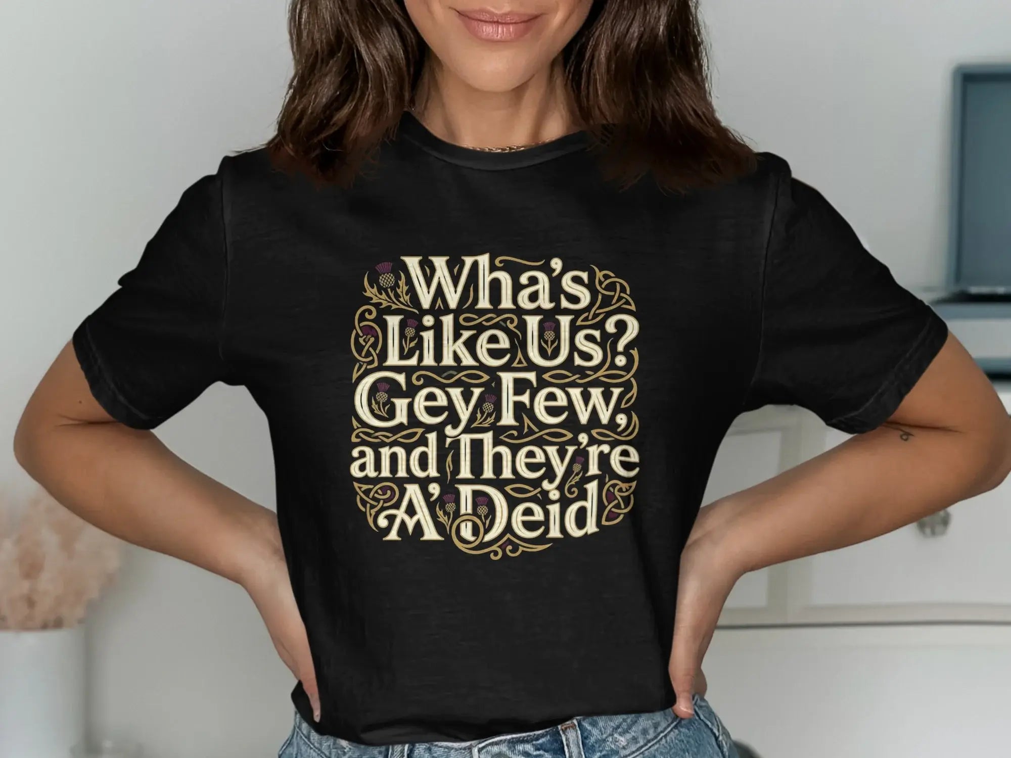 Black t-shirt with "Wha's Like Us? Gey Few and They're A'Deid" text in Celtic knotwork.