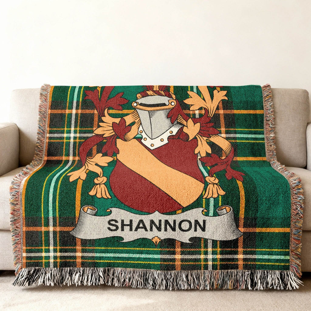 Tartan blanket with Shannon family crest on a sofa.