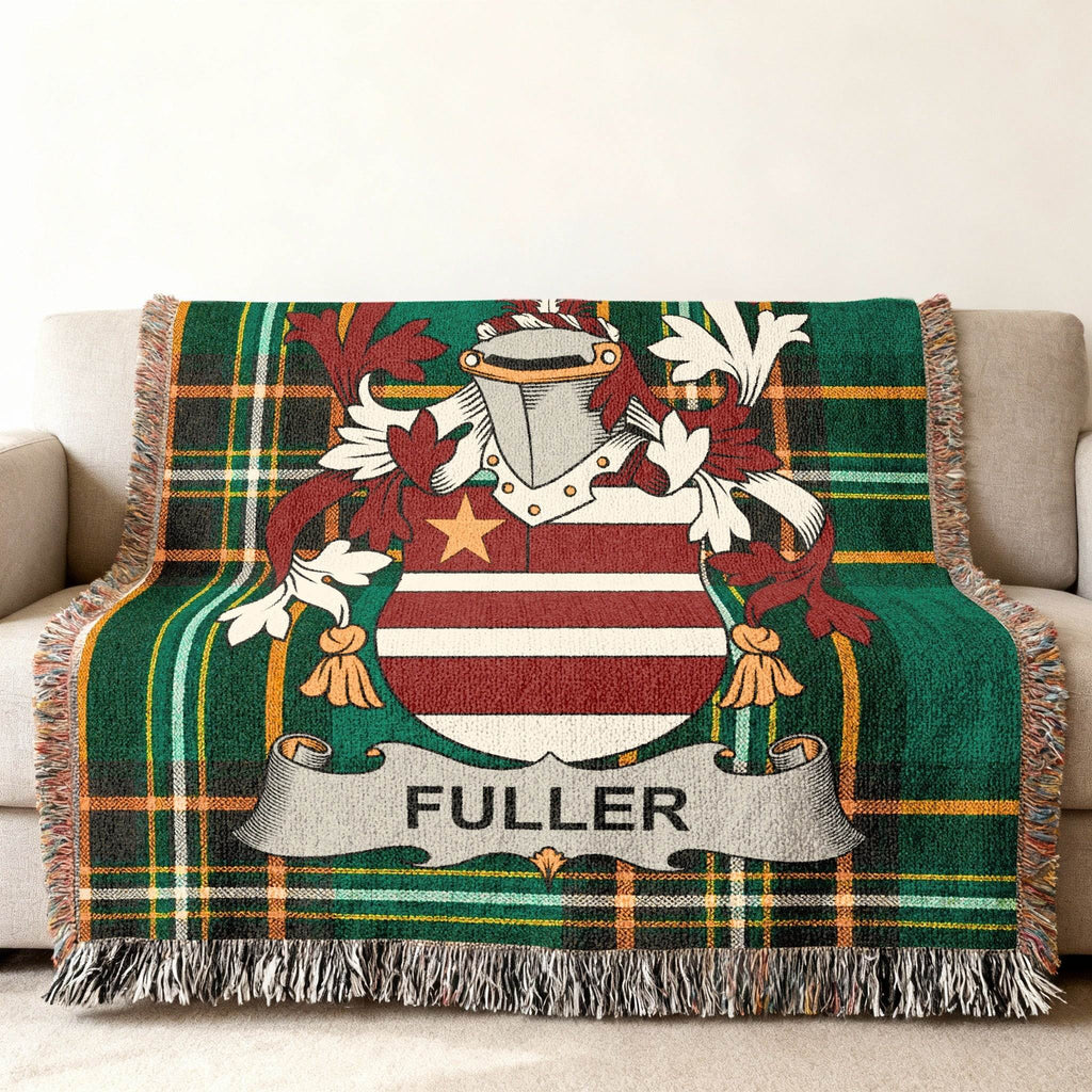 Green plaid throw blanket draped over a couch, featuring the Fuller family crest.