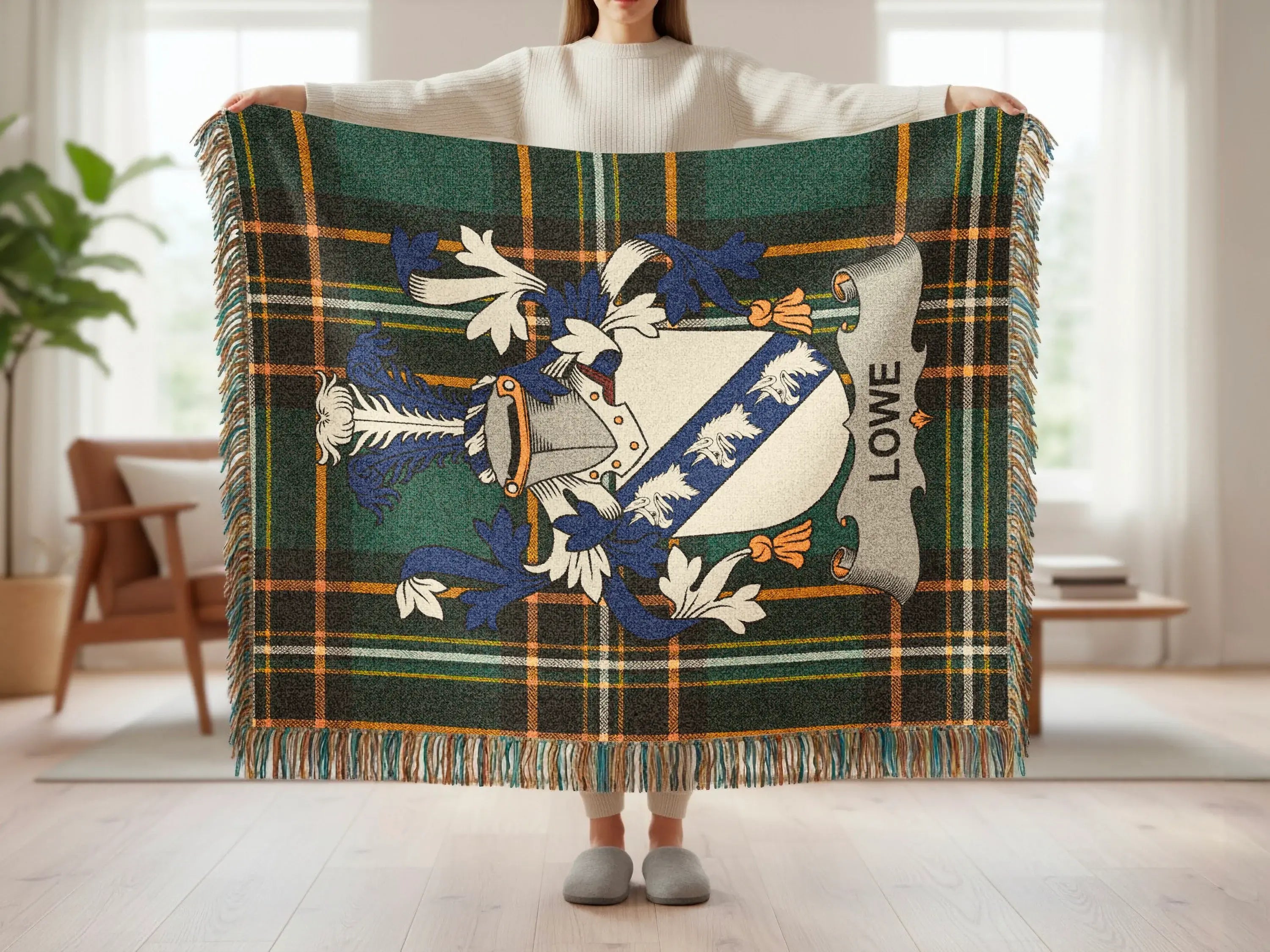 Lowe family crest displayed on a green and blue tartan plaid blanket.
