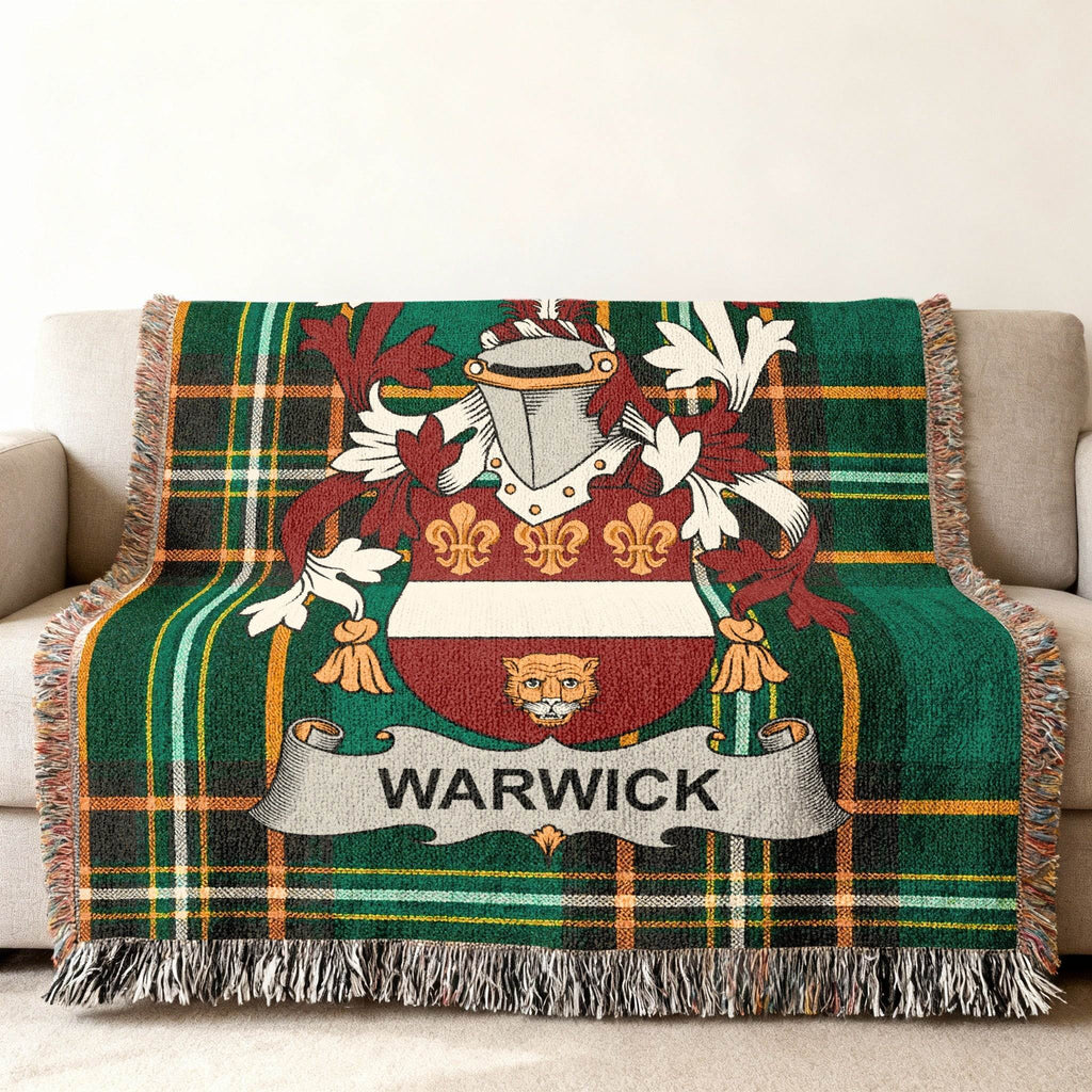 Woven tartan blanket with Warwick crest, draped over a couch.