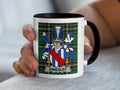 White mug with black rim displaying the Annesley family crest on a plaid background.