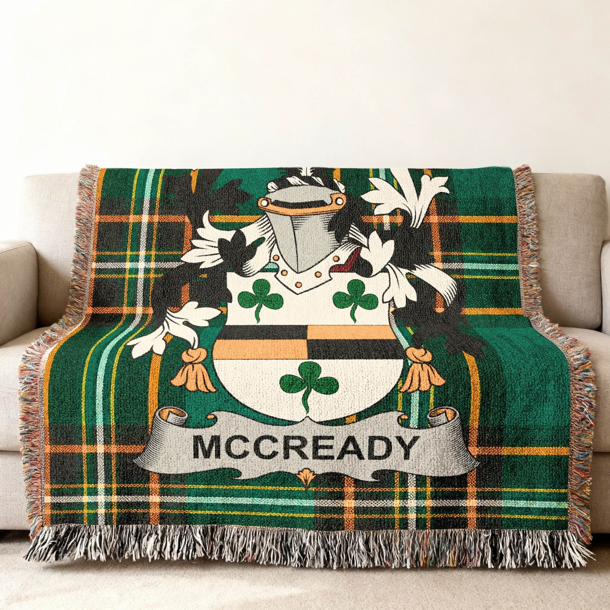 McCready tartan blanket with family crest displayed on a couch.