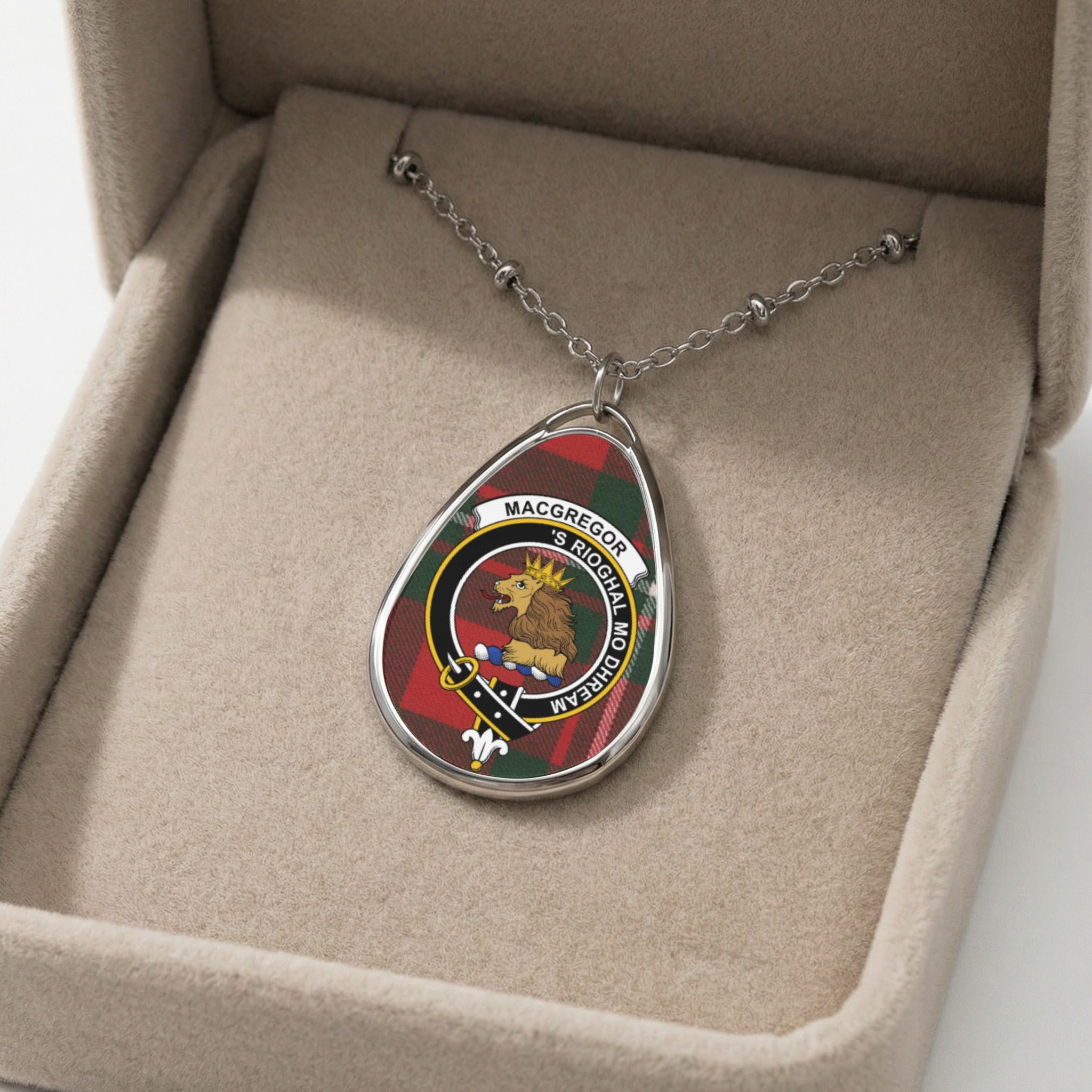 Macgregor clan pendant necklace with lion crest and tartan background in a jewelry box.