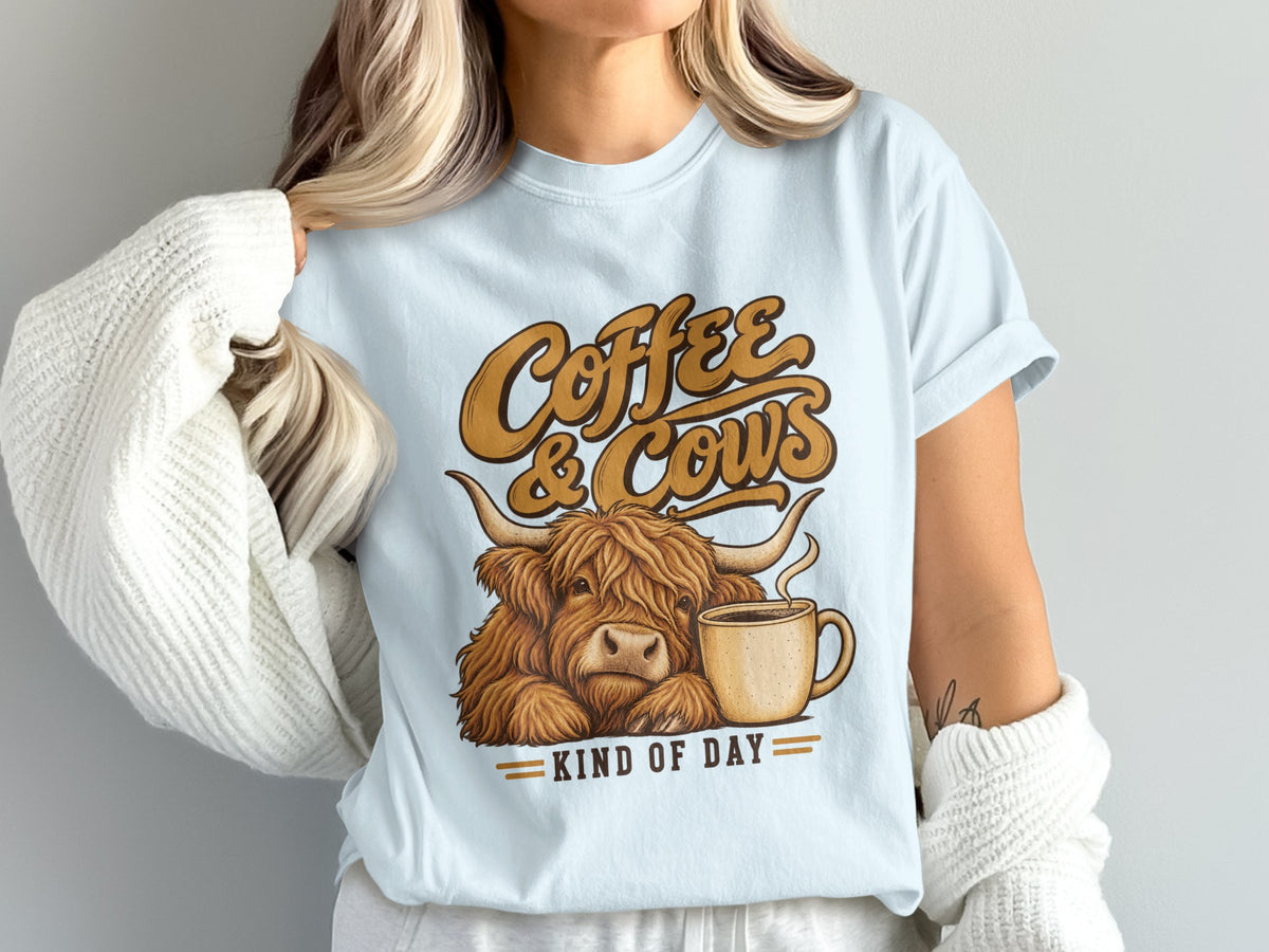 Model wearing the Coffee & Cows Kind of Day Highland cow Comfort Colors T-shirt in Chambray