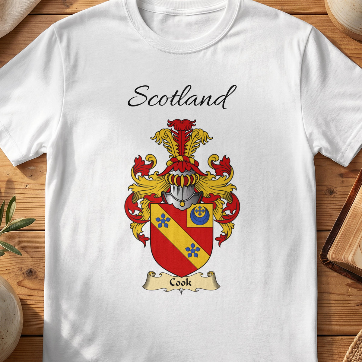 White Cook Scottish family shield T-shirt featuring a gold diagonal band with blue flowers on red