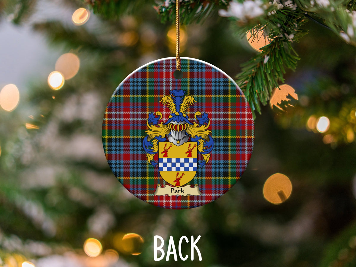 Park ceramic ornament detail showing a double-sided family shield on a Caledonia tartan background