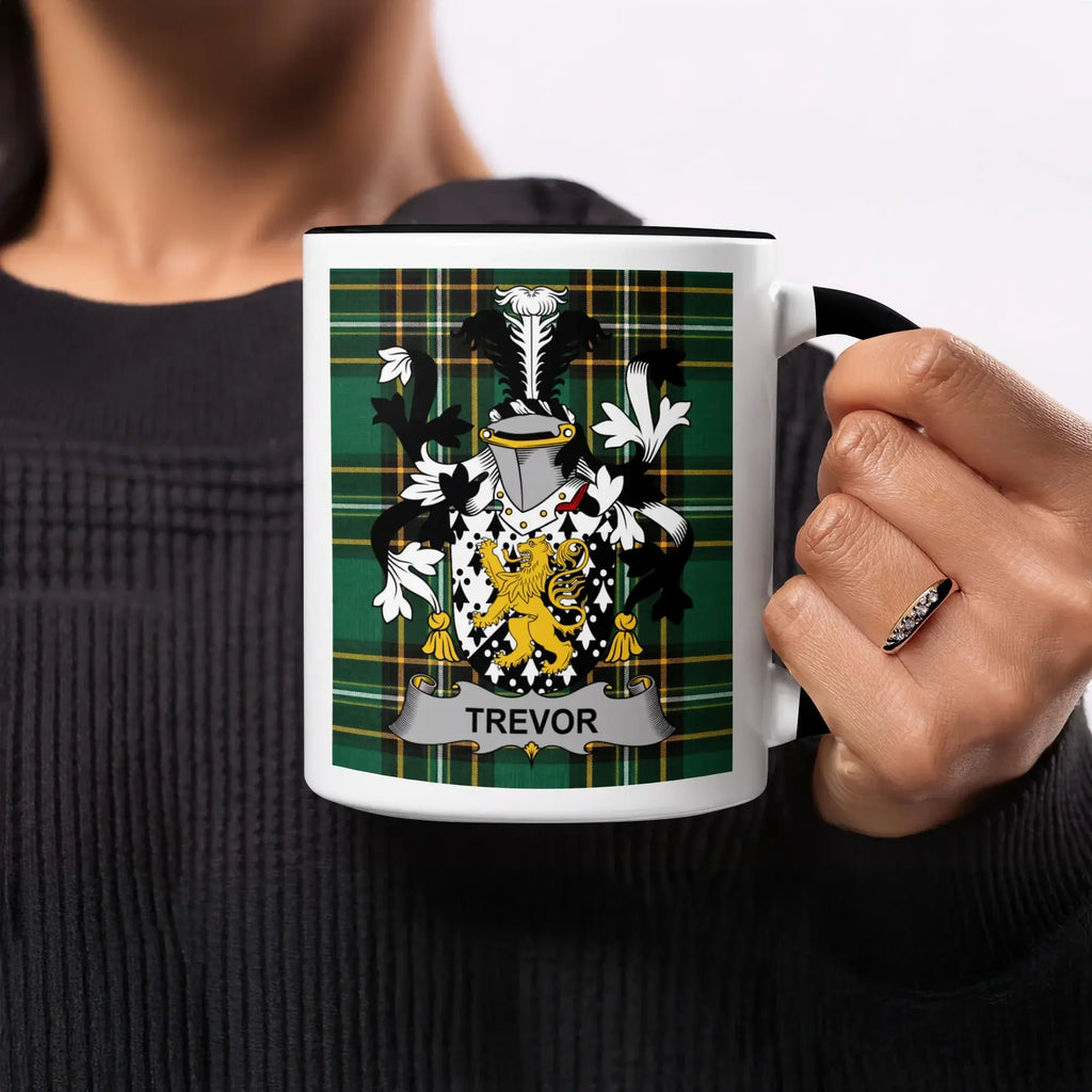 Mug featuring a coat of arms with the name TREVOR on a tartan background.