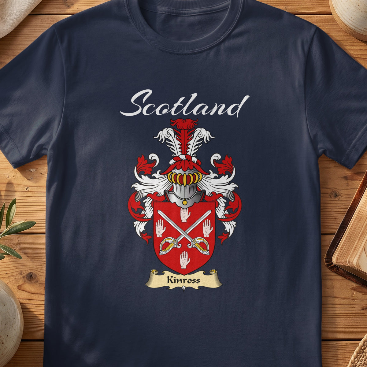 Navy Kinross family shield T-shirt featuring crossed blades and white hand motifs on red