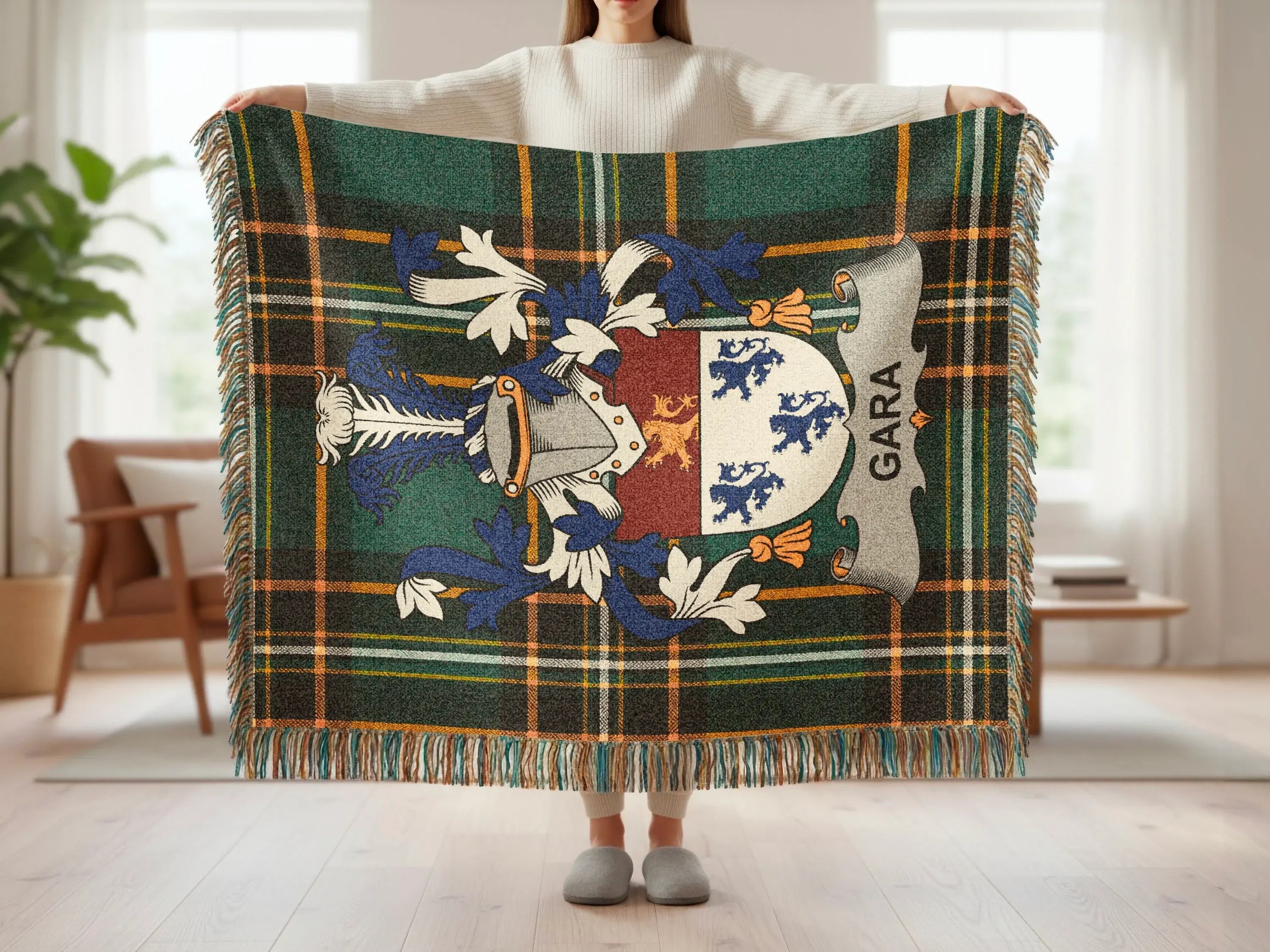 Tartan blanket with family crest displaying "GARA" in blue and white.