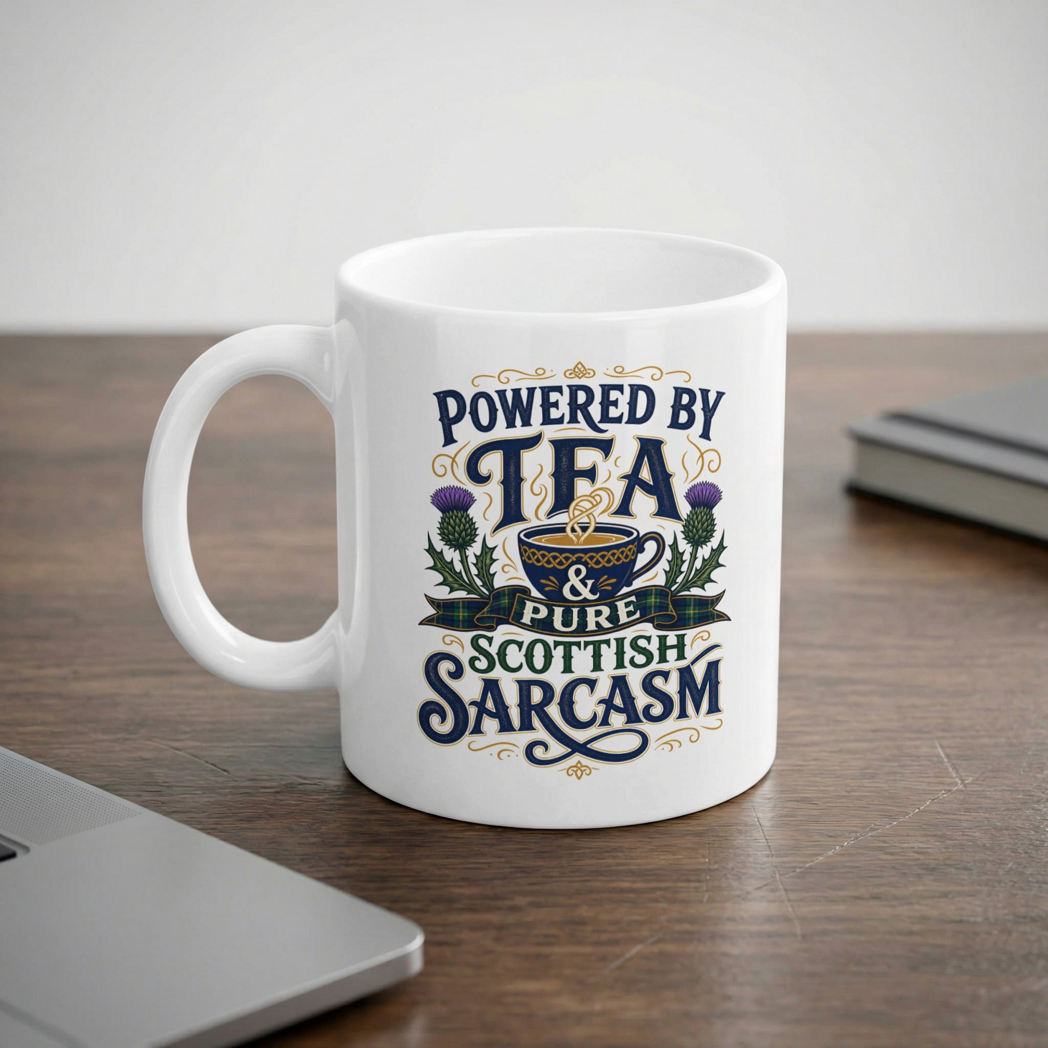 White mug with "Powered by Tea & Pure Scottish Sarcasm" text and thistle design.