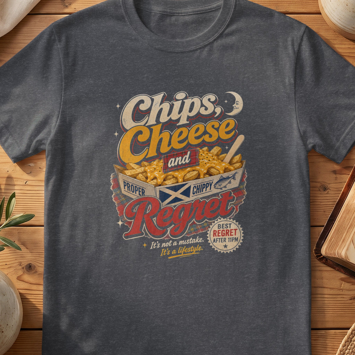 Dark grey Gildan 64000 unisex T-shirt flatlay with Chips Cheese and Regret Scottish graphic design