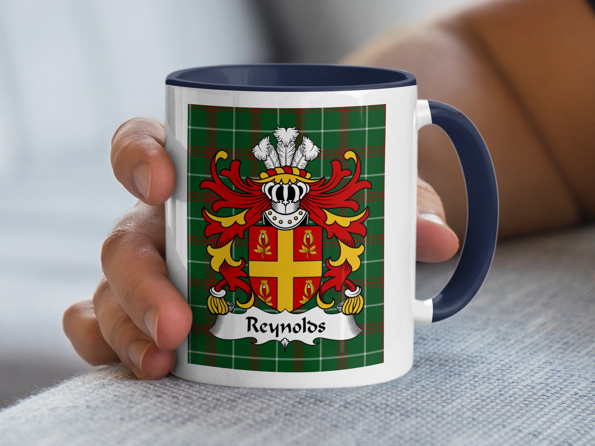 Mug with green tartan, Reynolds family crest, and dark blue handle.