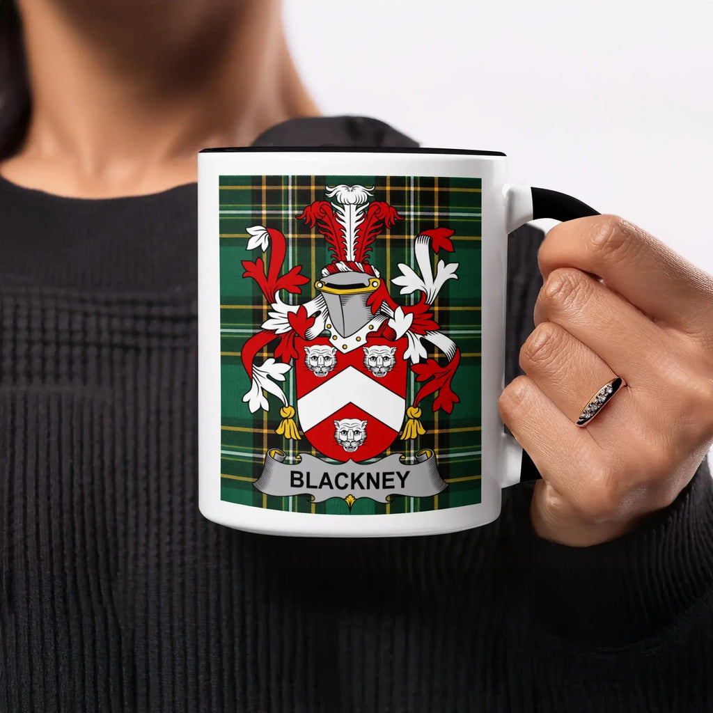 Mug with Blackney family crest on green plaid background.