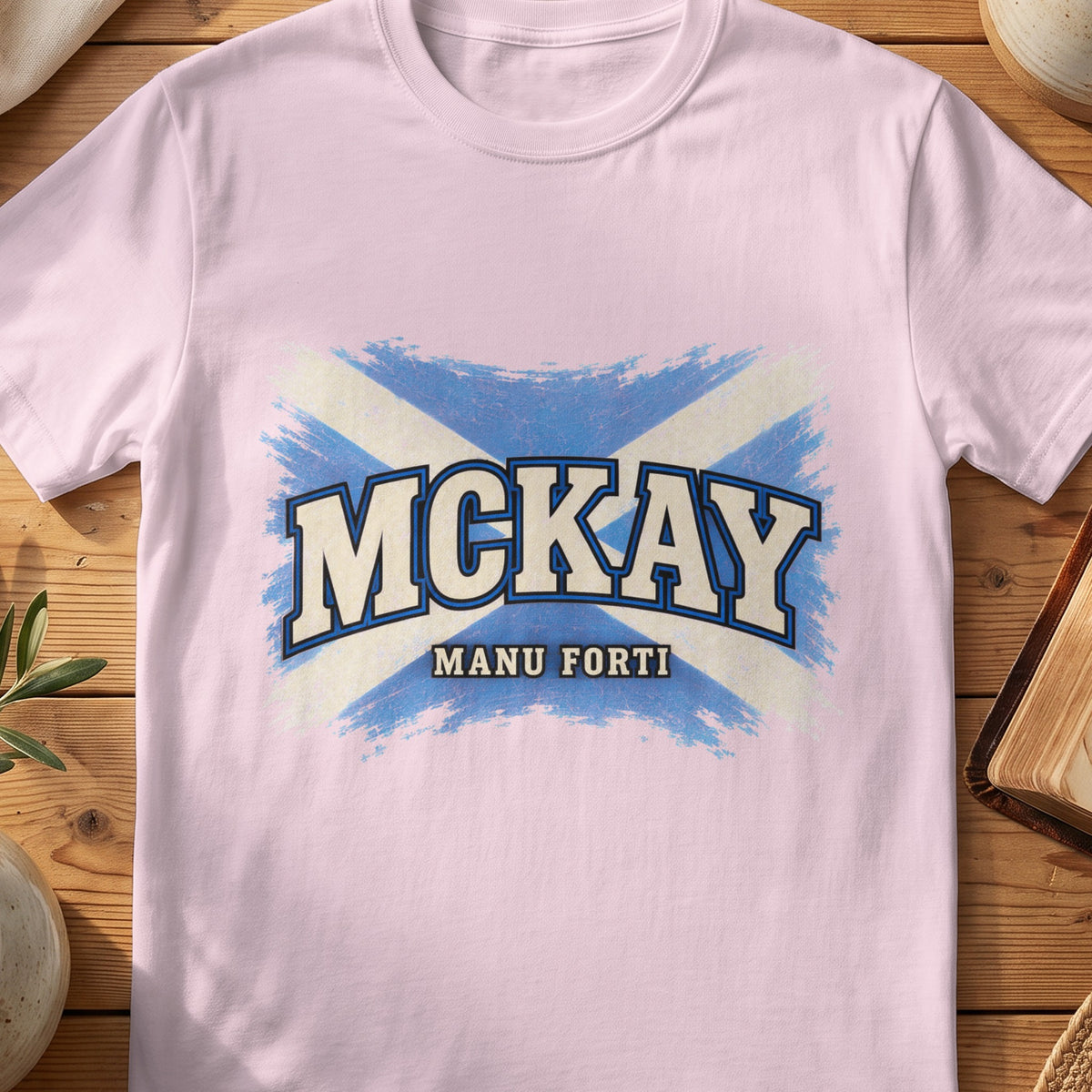 McKay Scottish Saltire T-shirt in Light Pink, with distressed blue and cream flag and “Manu Forti” lettering.