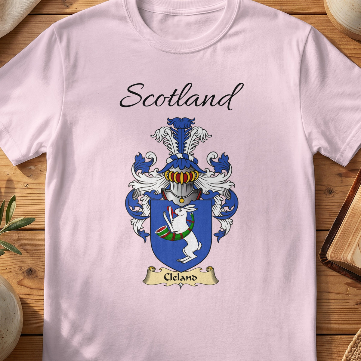 Light Pink Cleland Scottish family shield T-shirt featuring a white hare with a green hunting horn