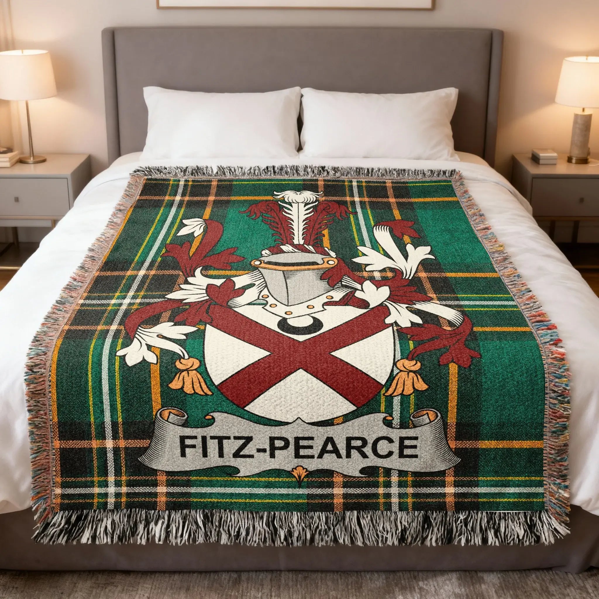 Tartan blanket with Fitz-Pearce coat of arms and fringe, draped on a bed.