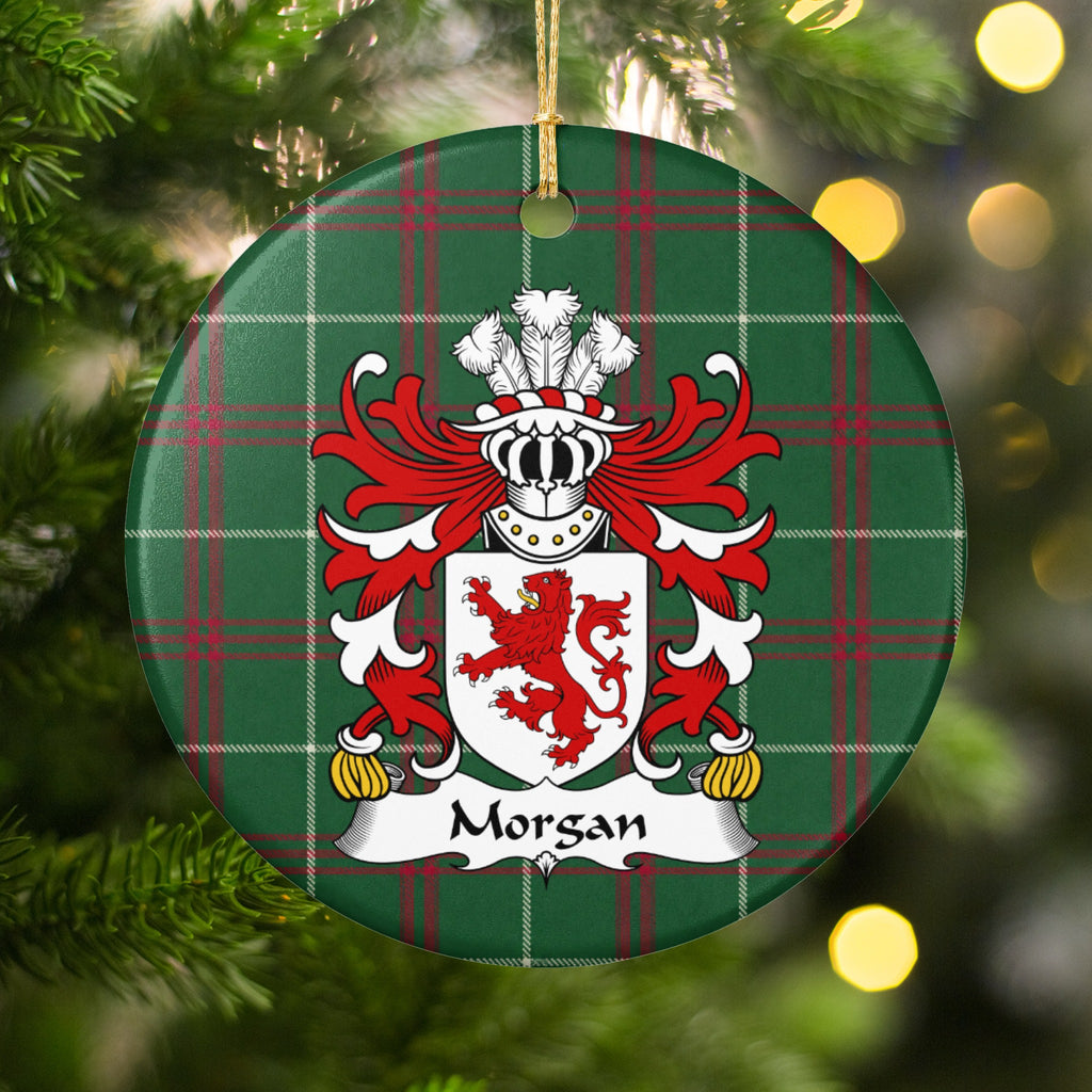 Morgan ornament, Style 1 hanging among Christmas tree branches and warm lights; a red lion on a white shield on Welsh national tartan.