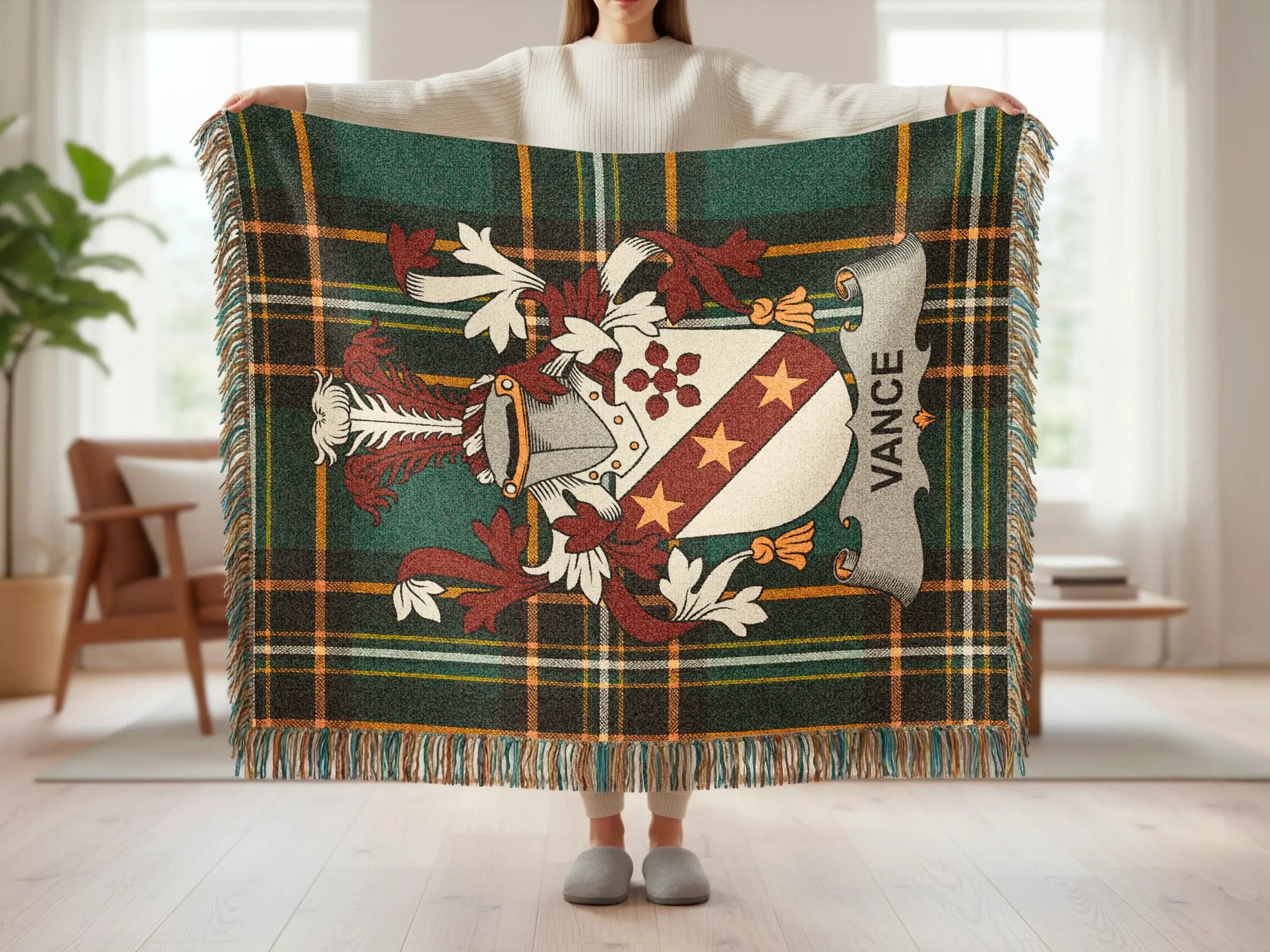 Green tartan blanket with Vance family crest and fringed edges.