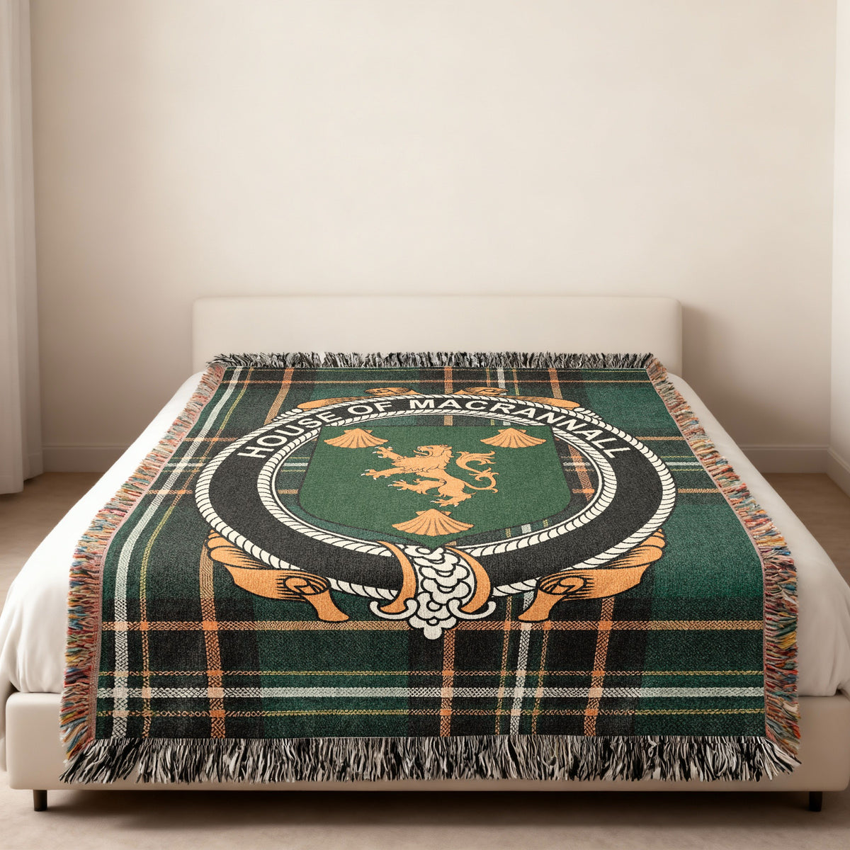 MacRannall family crest emblem woven blanket displayed on a bed
