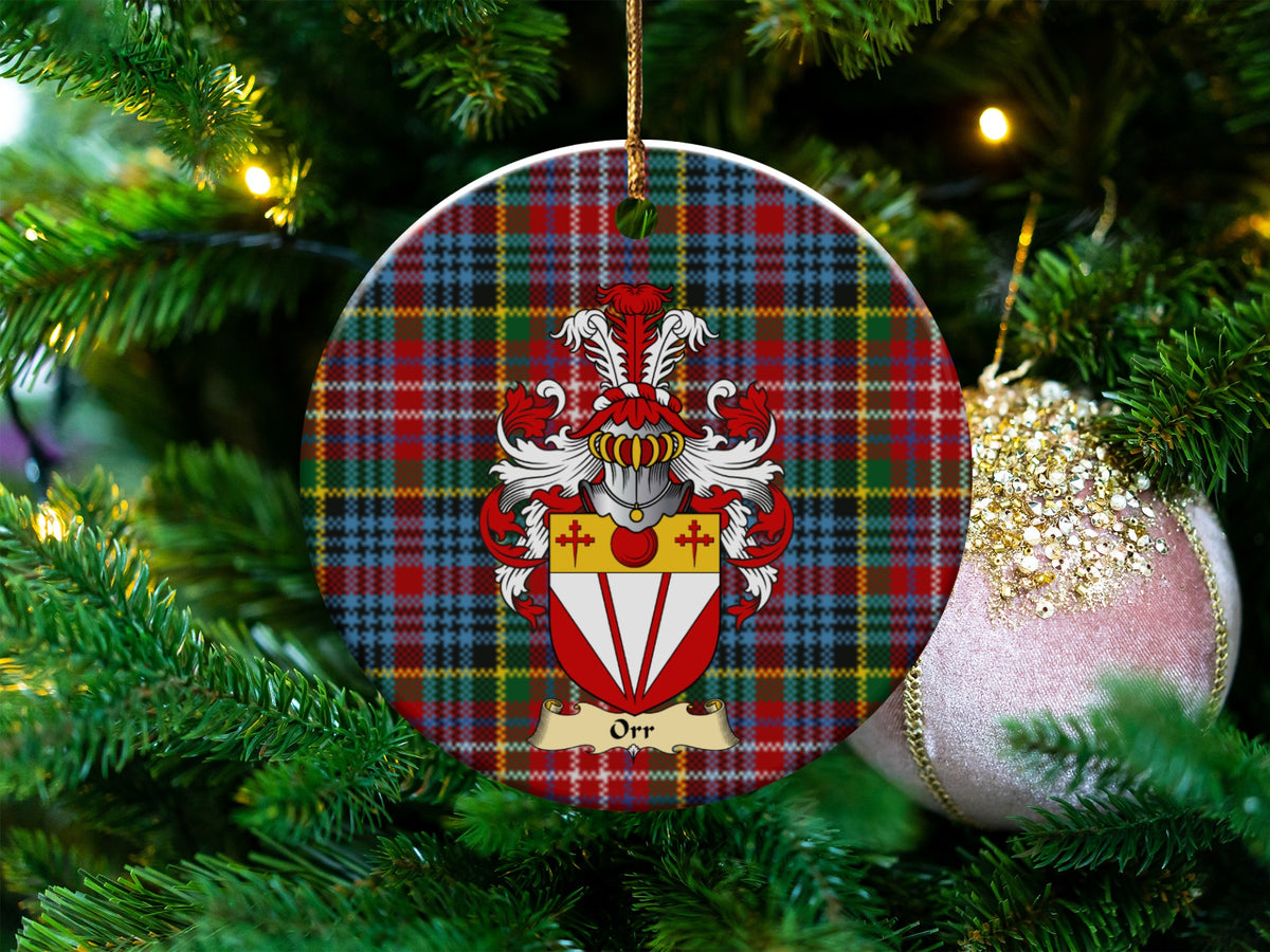 Orr Scottish clan ceramic ornament with family crest on a Caledonia tartan background, hanging on a Christmas tree