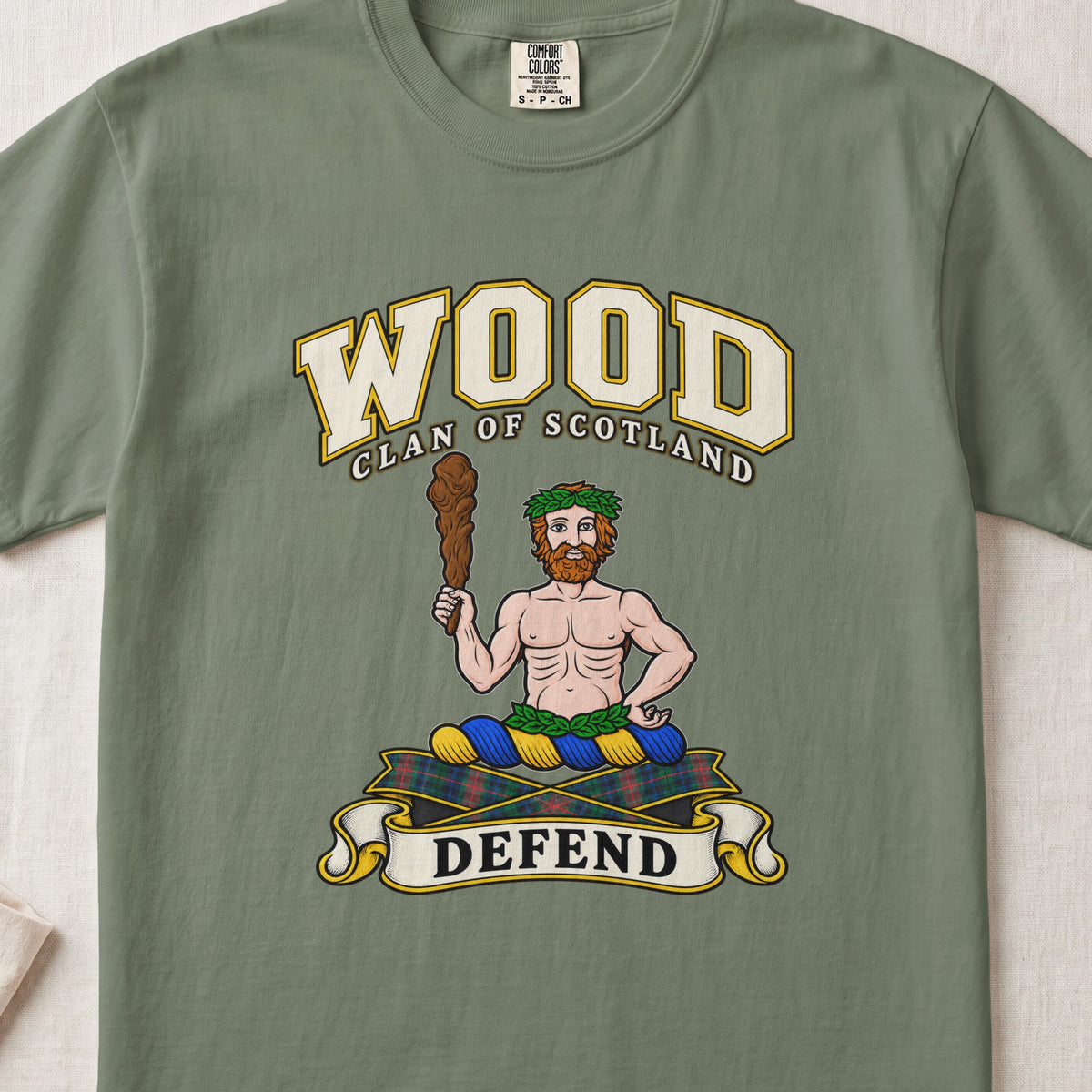 Wood Scottish clan T-shirt in Moss, front view with a bearded figure holding a wooden club and motto banner.