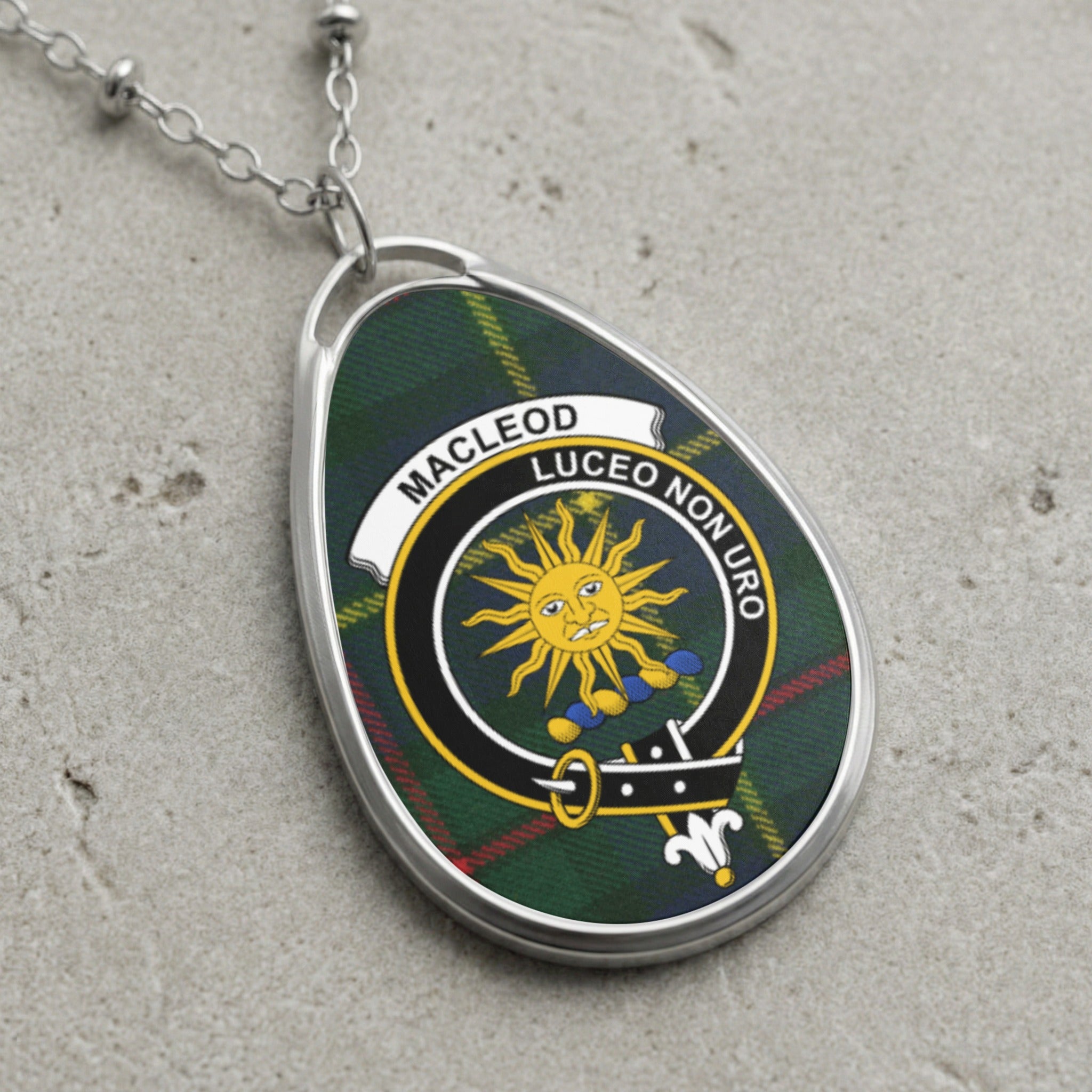 Silver oval pendant with MacLeod tartan and crest, silver chain.
