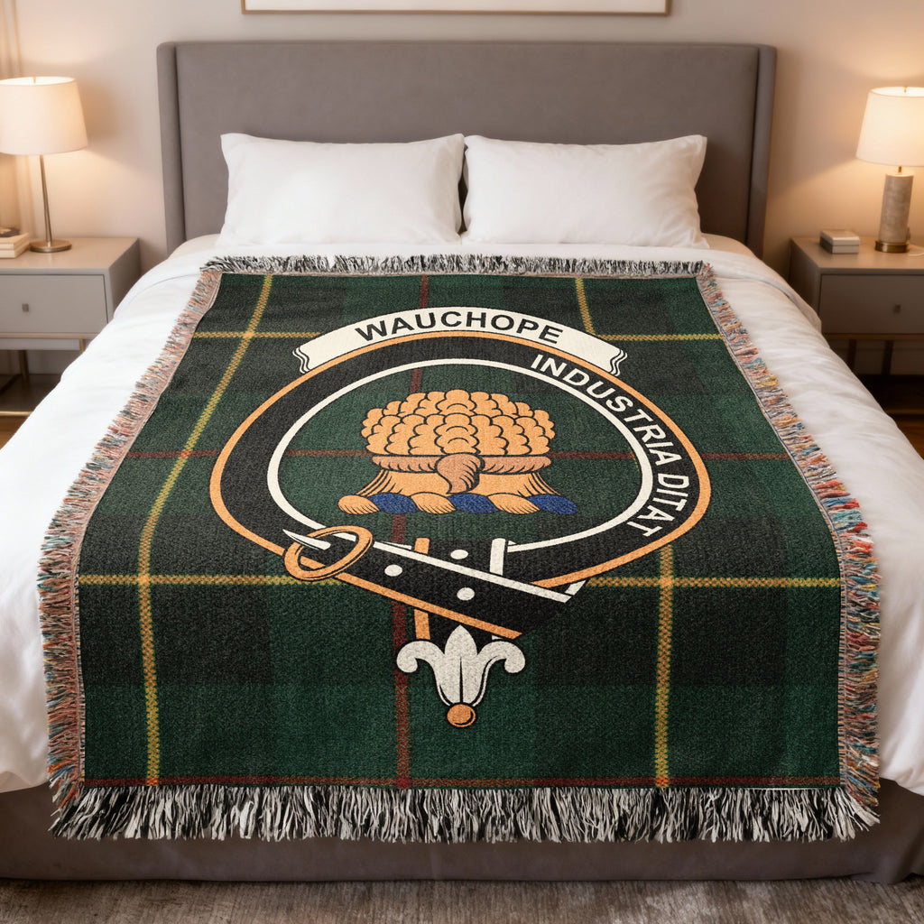 Wauchope woven blanket displayed on a bed, with two sheaves of wheat on a dark green with yellow lines tartan background