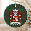 Davies Style 2 ornament hanging from a pale wooden branch; a black lion on a white diagonal band with two gold crescents on red on Welsh national tartan.