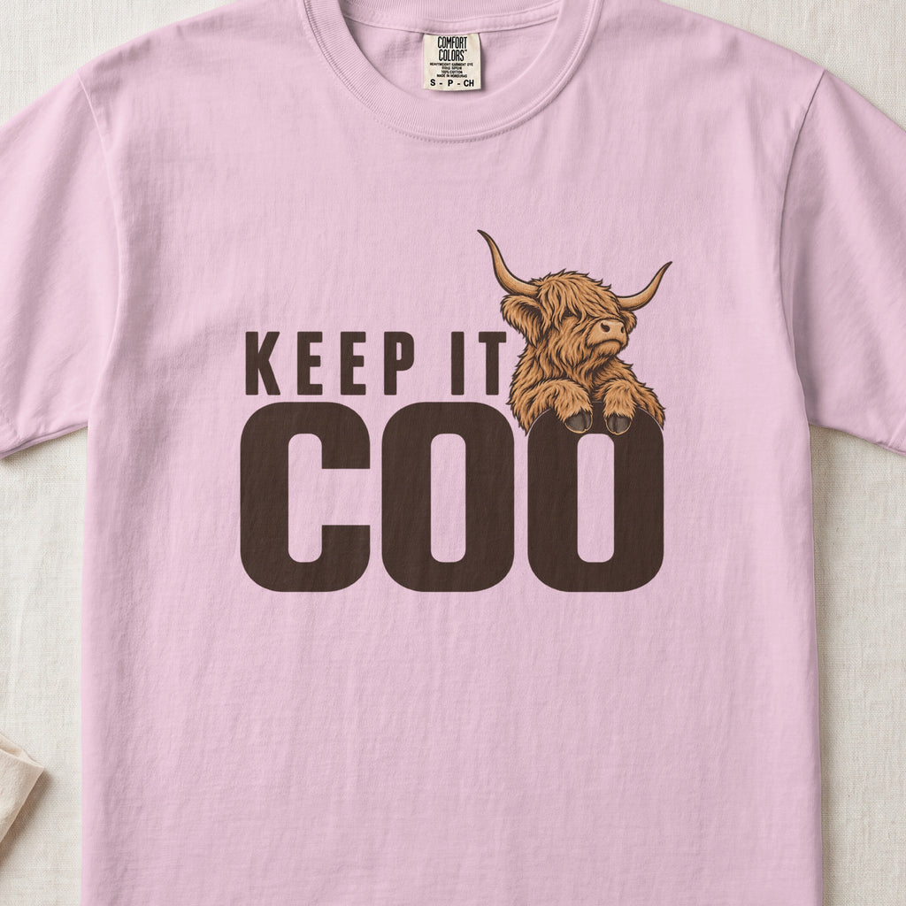 Keep It Coo Highland cow design on a Blossom Comfort Colors 1717 T-shirt, flat lay