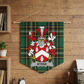 Byrne family crest on green tartan banner hanging on wooden wall
