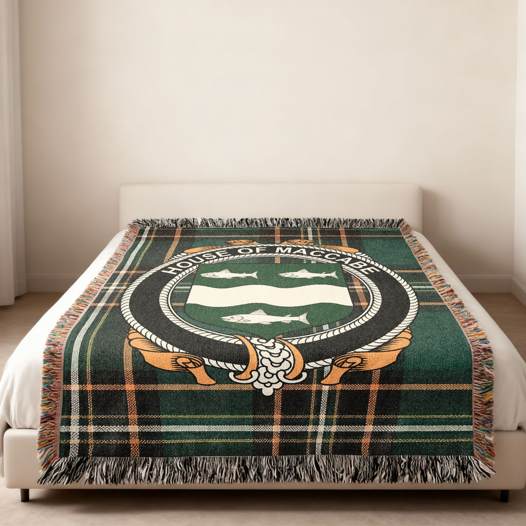 MacCabe family crest emblem woven blanket displayed on a bed