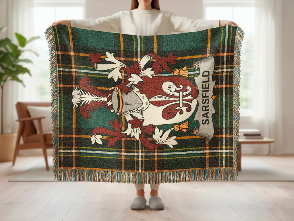 Tartan blanket with Sairsfield coat of arms and fringe, held by a person.