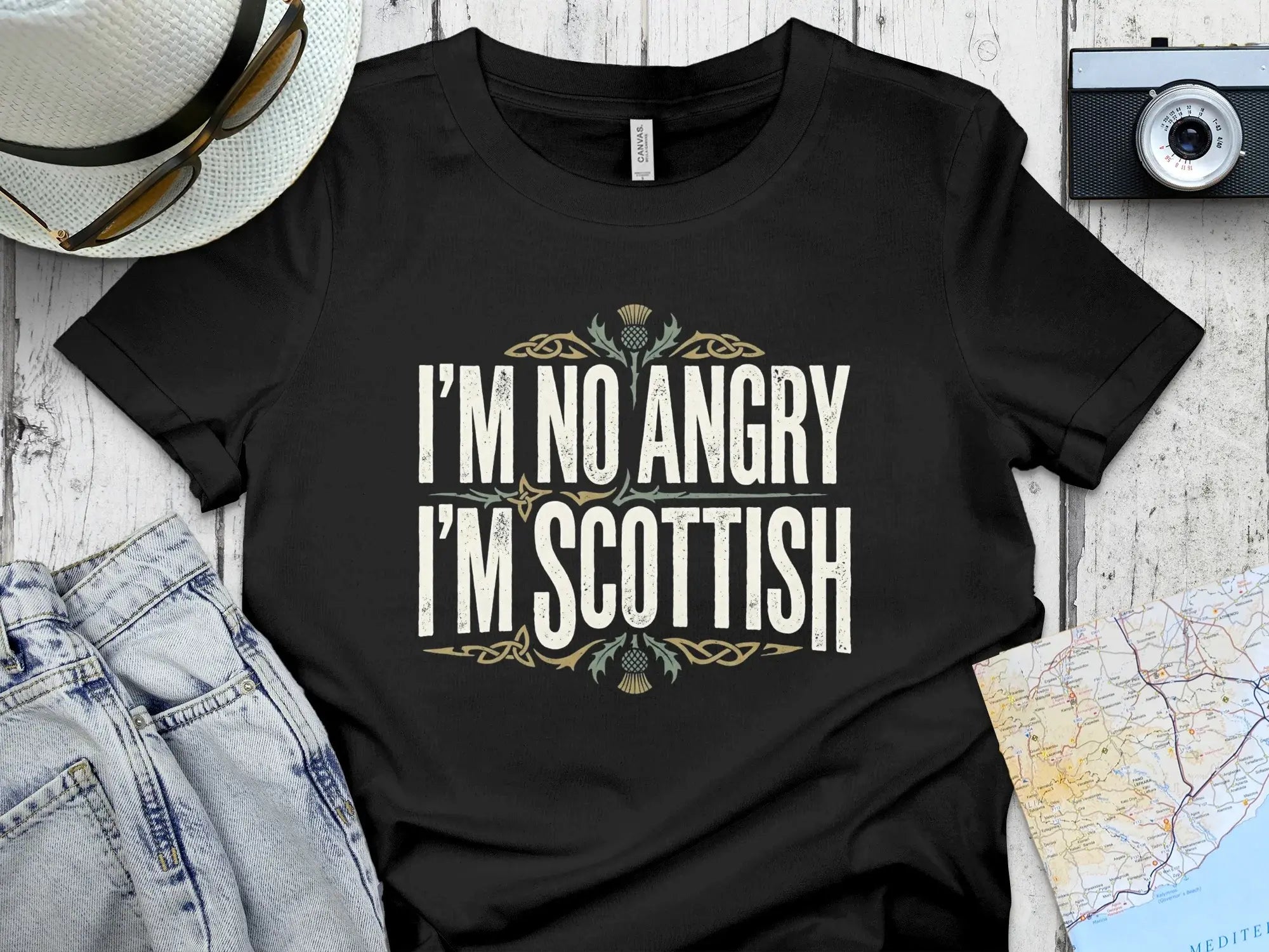 Black t-shirt with "I'M NO ANGRY I'M SCOTTISH" text and thistle graphic.