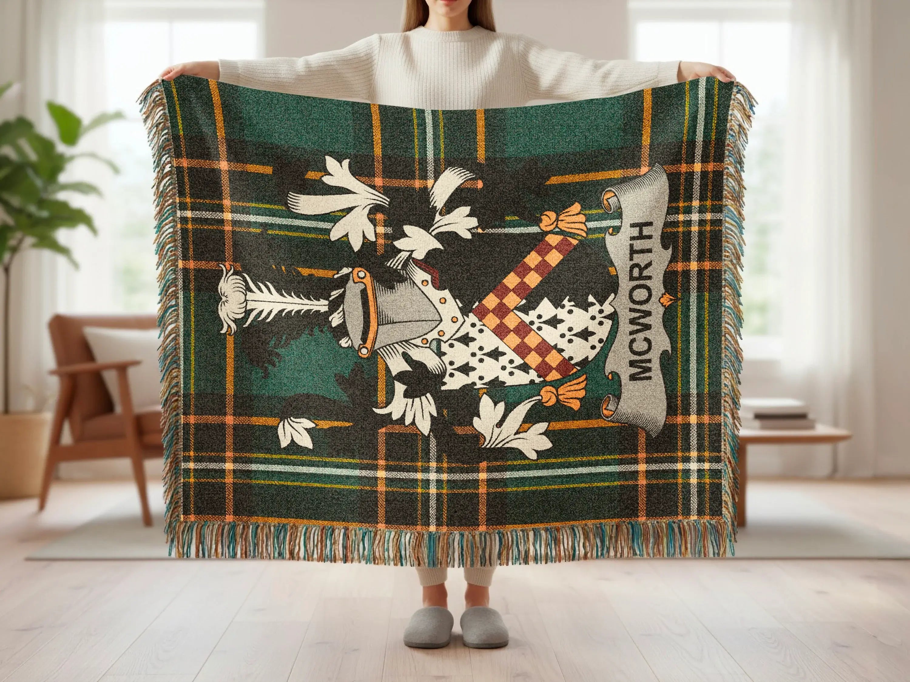 Green tartan throw blanket with a crest featuring the name "MCWORTH".