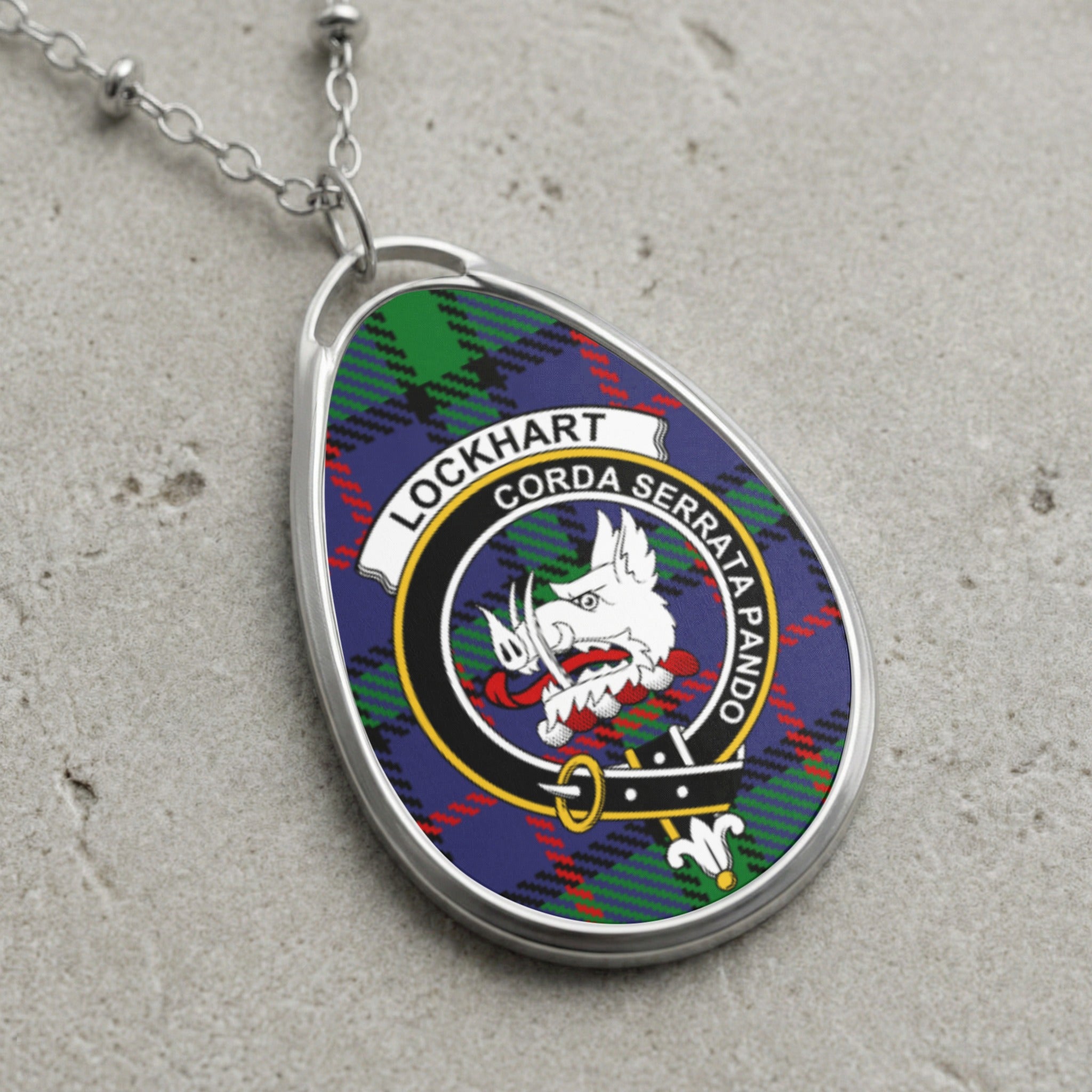 Lockhart clan Scottish tartan necklace with clan crest on tartan background