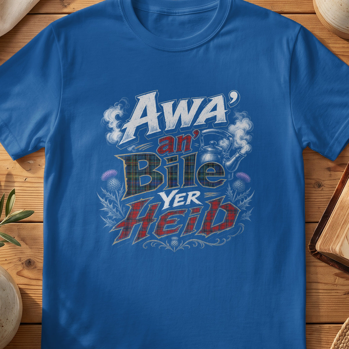 Blue t-shirt with "Awa' an' Bile Yer Heid" text, tartan, and thistles.