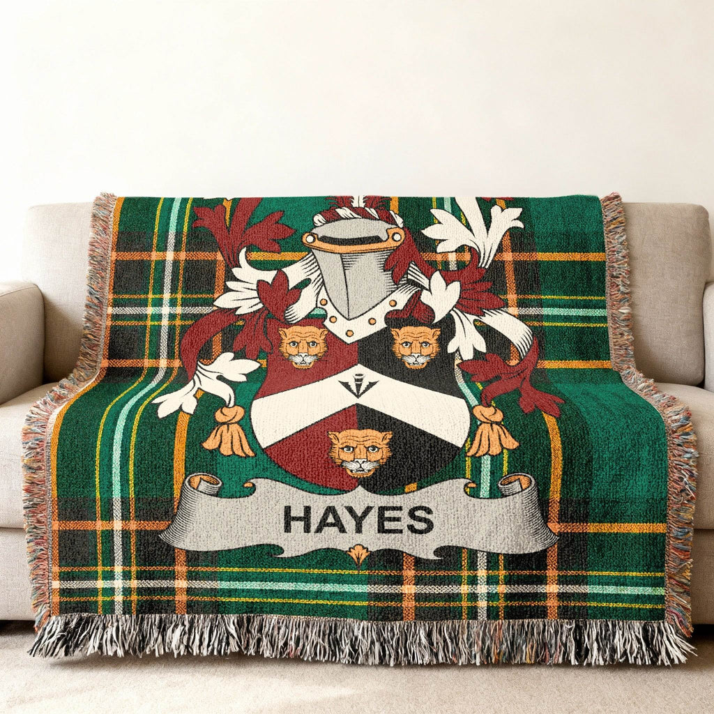 Woven blanket with green plaid pattern featuring the Hayes family crest.
