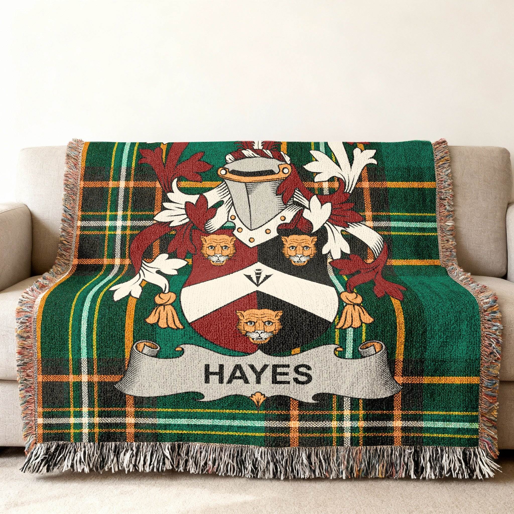 Woven blanket with green plaid pattern featuring the Hayes family crest.