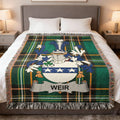 Tartan blanket with the Weir family crest and name in blue, white, and green.