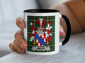 Mug with a coat of arms and the name "AMORY" on a plaid background.