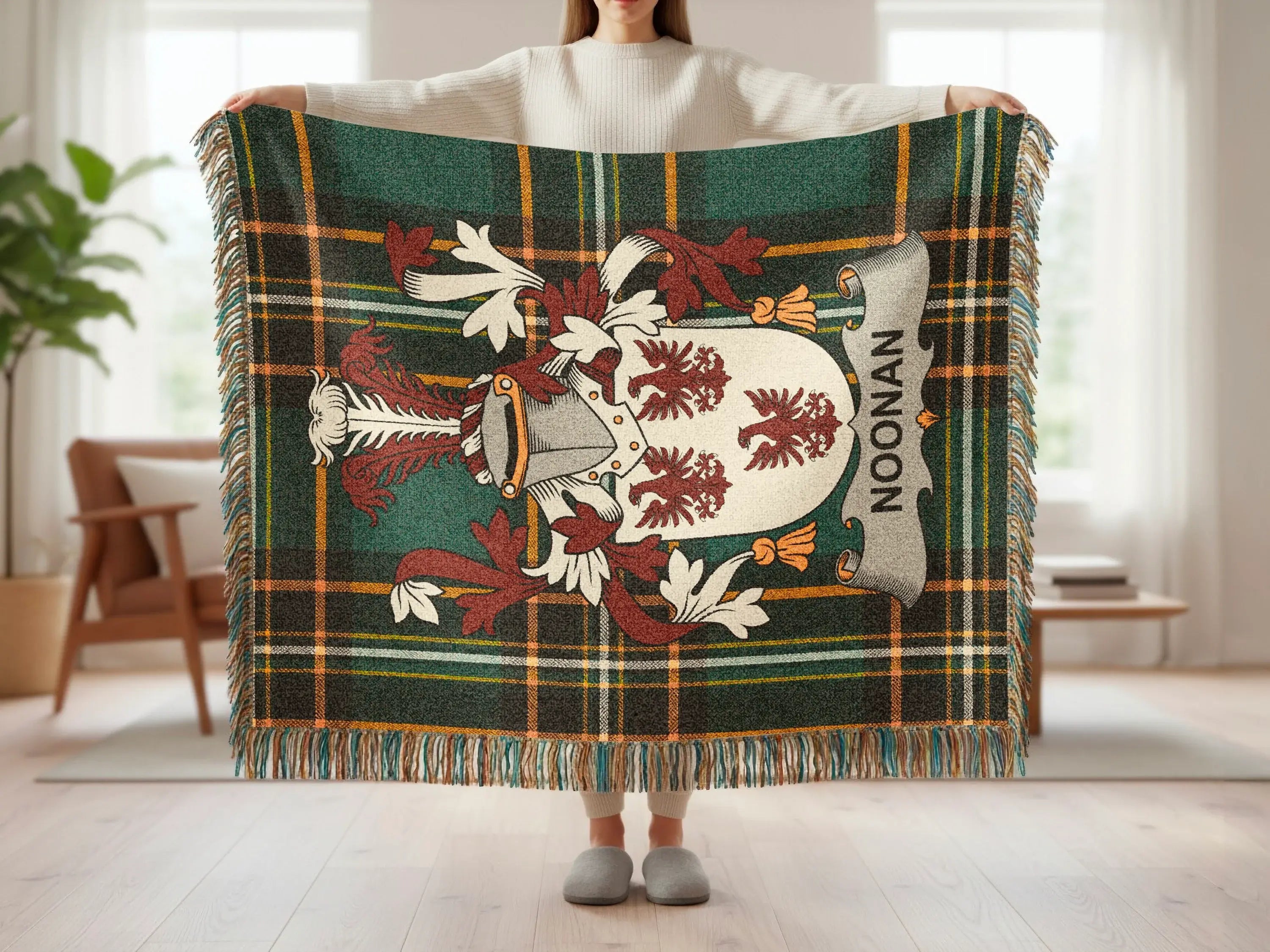 Plaid blanket with a coat of arms featuring the name "Noonan."