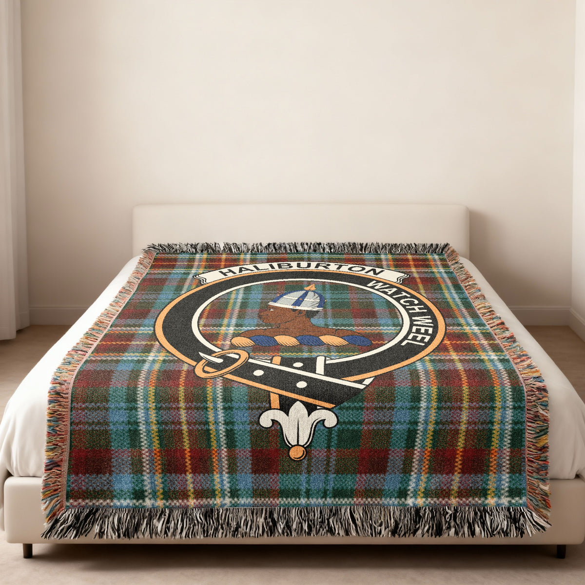 Haliburton Scottish woven blanket spread across a bed, showing the full crest design and tartan background
