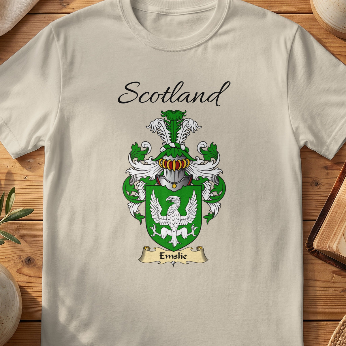Sand Emslie Scottish family shield T-shirt featuring a white spread-winged bird on green