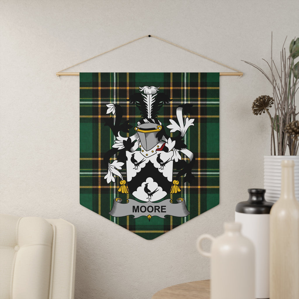 Moore family crest on a green and black plaid pennant hanging on a wall.