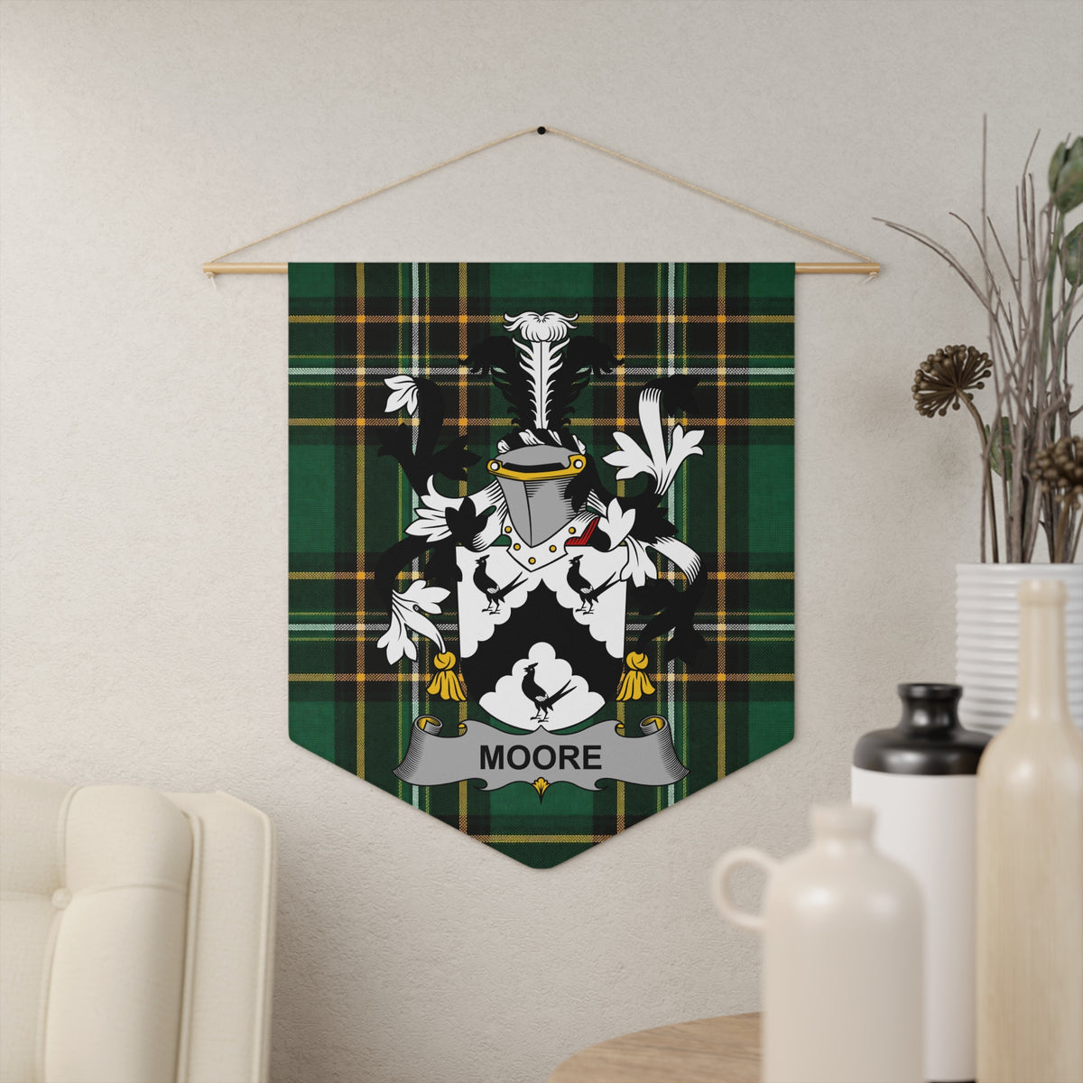 Moore family crest on a green and black plaid pennant hanging on a wall.