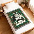 Green tartan woven throw blanket with "Thomas" family crest and birds.