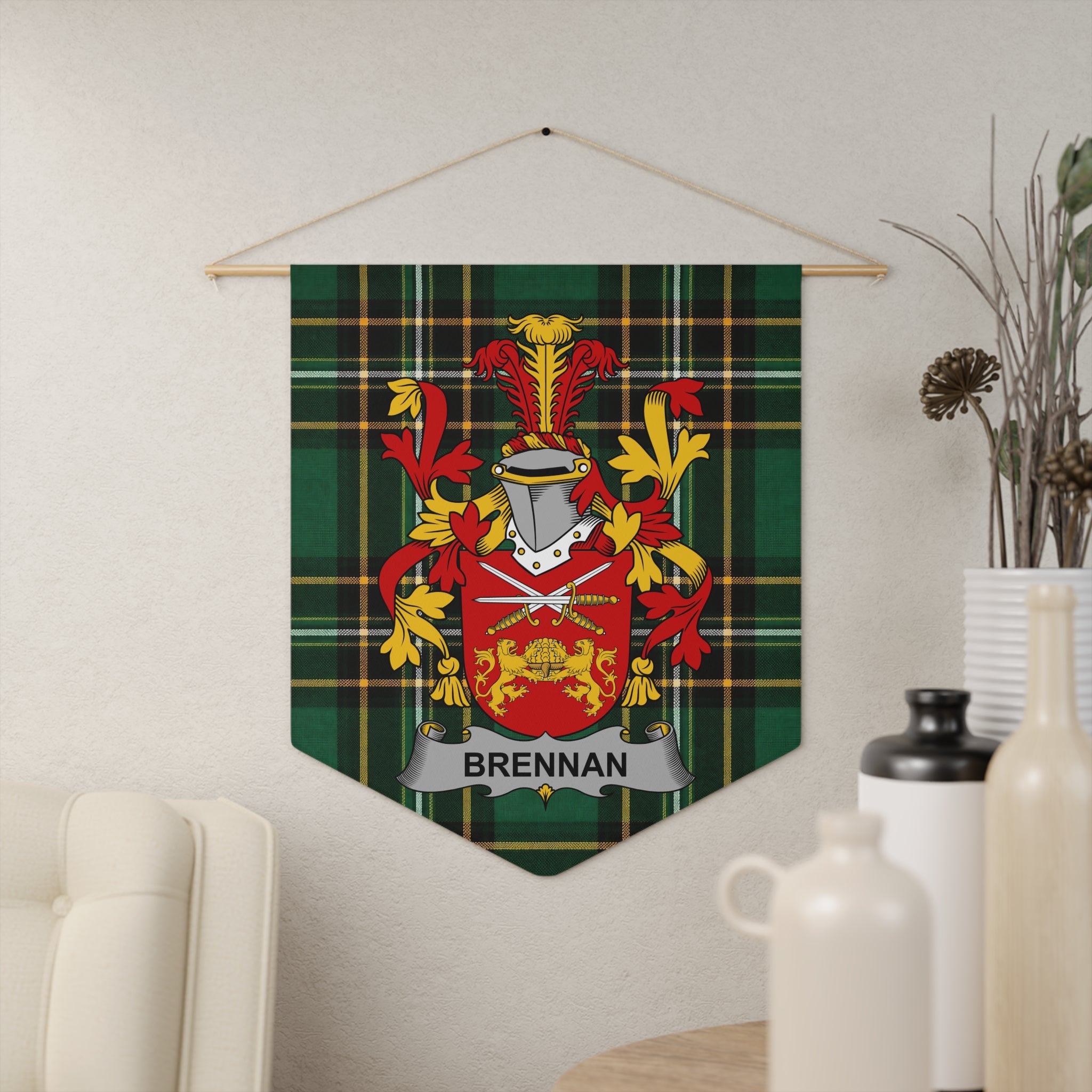 Brennan family crest on green tartan pennant hanging on wall.